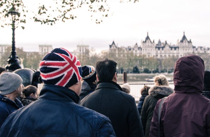 Man in union jack hat in front of Thames