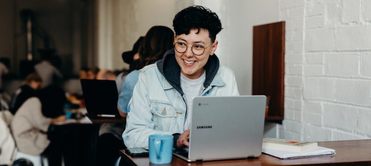 person smiling on laptop